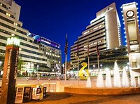 A city square with many buildings and fountains.